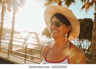Travel, peace and senior woman at the beach for summer, walk and weekend fun in Bali. Sun, smile and elderly person on holiday at the sea to relax during the start of retirement by the ocean
