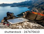 Travel photographer equipment on rocky mountain with beautiful landscape on the background