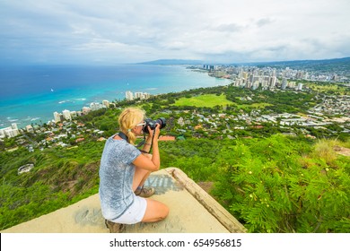 Travel Photographer Takes A Shot Of Honolulu And Waikiki Beach, Oahu In Hawaii From Diamond Head State Monument. Nature Photographer Taking Pictures Outdoors During Hawaiian Hiking Diamond Head Hike.