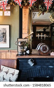 Travel Photography Still Life Of Fireplace In English Country Pub With Union Jack Bunting, Hooe, East Sussex UK