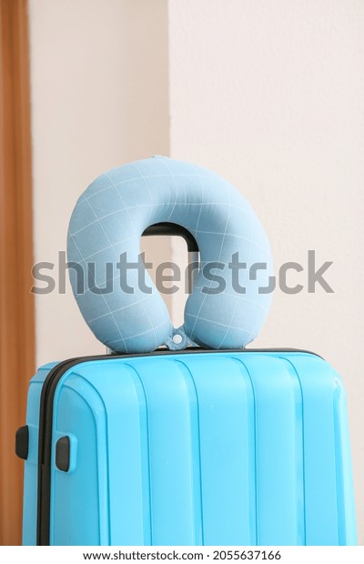 Travel pillow and suitcase in\
room