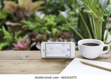 Travel Plan,mobile Phone,coffee Cup,paper And Pencil On Wooden Table In Green Garden Outdoor