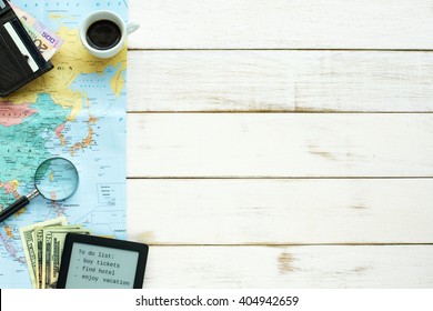 Travel Planning Essentials. Map, Magnifier, Wallet, Money, Coffee, To-do List On A White Wooden Background. Copy Space.