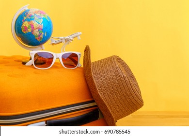 Travel Planning For Holiday Vacation Trip Concept With Airplane And Globe On Wooden Table And Yellow Background