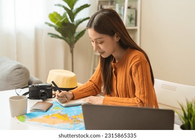 Travel planning, vacation, holiday trip concept, asian young tourist woman hand take note, check list using laptop searching information booking ticket or hotel online, preparation for journey trip. - Powered by Shutterstock