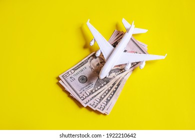 Travel preparation concept of airplane, money, passport, on yellow background. Selective focus.holidays