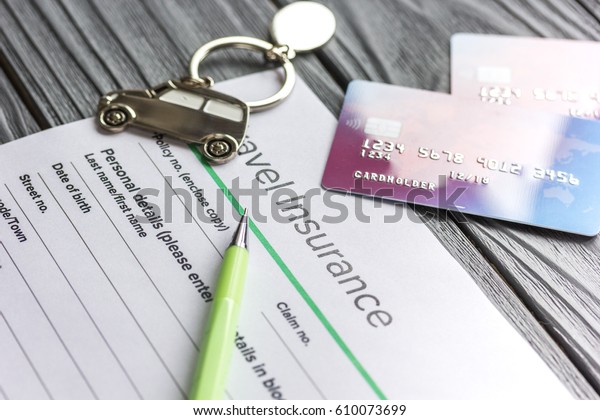Travel preparation concept with insurance and cards\
on wooden table