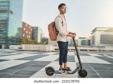 Travel, scooter and student in city, street or outdoors on road on eco friendly transportation. Technology, sustainability and male from India on electric moped commuting to college or university.