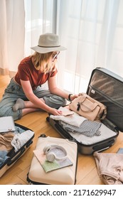 Travel. Staycation.local travel new normal.Girl packing luggage in suitcase and travel documents Travel,tourism,vacation,relocation.Mental health and travel vacation Film grain - Shutterstock ID 2171629947