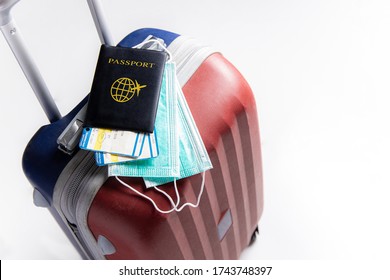 Travel Suitcase / Luggage, Passport, Air Ticket And Mask. Travel Ban During The Pandemic Of  Coronavirus Or Covid-19 