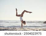 Travel, summer and girl with handstand on beach on vacation, energy and gymnastic skills with ocean waves. Woman, sea and upside down in swimwear on holiday in California, active and balance on sand.