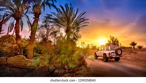 Travel, SUV rides a desert road at beautiful sunset, extreme travel adventure in nature - Powered by Shutterstock