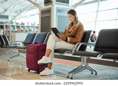 Travel, tablet and woman relax in airport lobby, social media or internet browsing. Immigration, technology and female with touchscreen for networking, web scrolling and waiting for flight departure. - Powered by Shutterstock