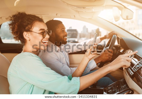 Travel Together. African-American Couple Using\
Navigator System, Driving\
Car