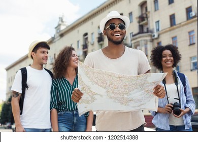 Travel Together. Happy Hipsters Using Navigation Map To Explore The City