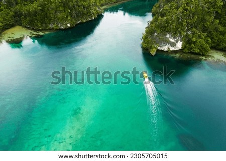 Travel, top view and boat on island river for adventure, holiday and vacation in Mauritius. Nature, sea and aerial drone of yacht in tropical water for transport, sailing and traveling on islands