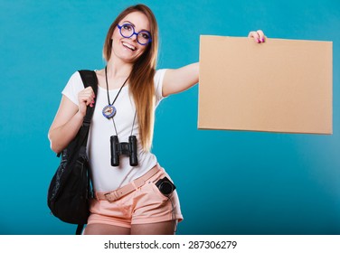 Travel and tourism active lifestyle concept. Woman tourist hitchhiking with blank sign for text on blue