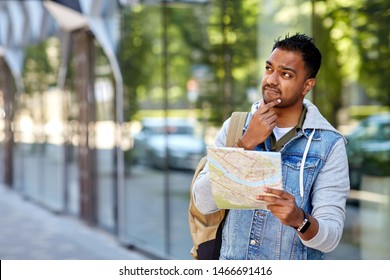 Travel, Tourism And Backpacking Concept - Indian Man Traveling With Backpack And Map In City Searching Location