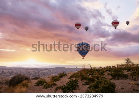 Travel and tourism by Turkey. Famous sightseeing Cappadocia, Anatolia. Beautiful landscape with mountains, caves and baloons in the sky.