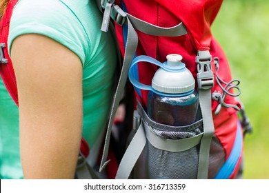 Travel, Tourism, Hike And People Concept - Close Up Of Woman With Water Bottle In Backpack Pocket