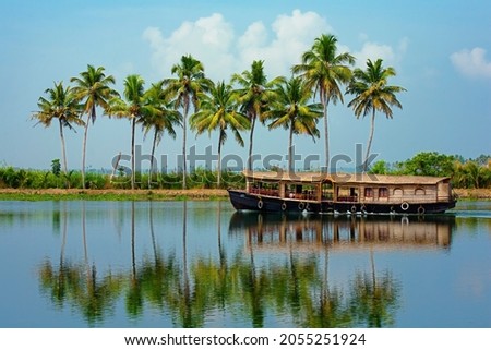 Travel tourism Kerala background - houseboat on Alleppey backwaters. Kerala houseboat image