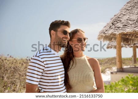 Similar – Image, Stock Photo A woman in sunglasses and a striped top holds her hair near the river with her hands
