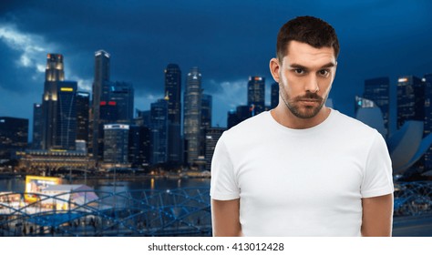 travel, tourism, people concept - young man portrait over night singapore city background - Powered by Shutterstock