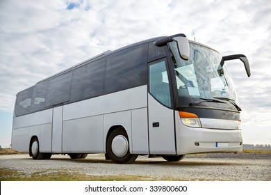 travel, tourism, road trip and passenger transport - tour bus parked outdoors