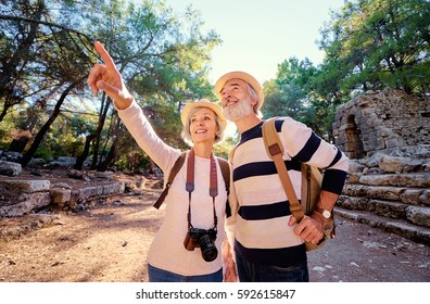 Travel And Tourism. Senior Family Couple Walking Together On Ancient Sightseeing.