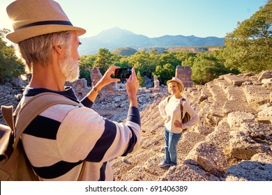 Travel And Tourism. Senior Family Couple Taking Photo Together On Ancient Sightseeing.