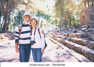 Travel And Tourism. Senior Family Couple Walking Together On Ancient Sightseeing.