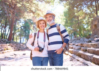 Travel And Tourism. Senior Family Couple Walking Together On Ancient Sighseeing.