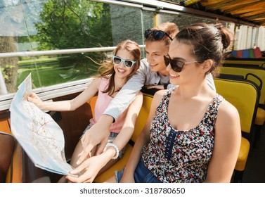 Travel, Tourism, Summer Vacation, Sightseeing And People Concept - Group Of Smiling Teenage Friends In Sunglasses With Map Traveling By Tour Bus