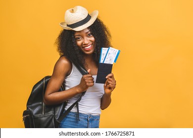 Travel, Tourism And Vacation Concept - Happy Young African American Black Woman With Air Tickets Isolated Over Yellow Background.