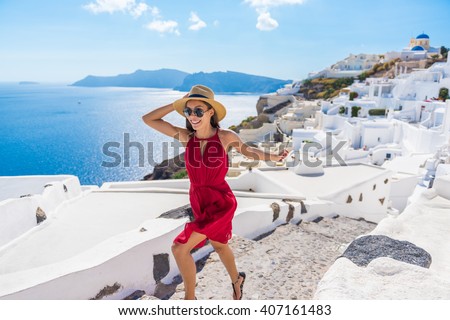 Travel Tourist Happy Woman Running Stairs Santorini, Greek Islands, Greece, Europe. Girl on summer vacation visiting famous tourist destination having fun smiling in Oia. 
