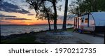 Travel trailer camping at sunset by the Mississippi river in Illinois at sunset panorama