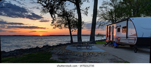 Travel trailer camping at sunset by the Mississippi river in Illinois at sunset panorama - Shutterstock ID 1970212735