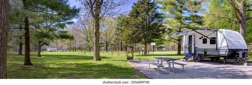 Travel Trailer Camping In The Woods At A Campground