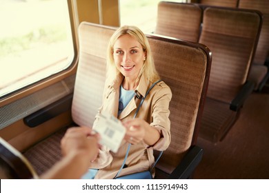 Travel And Transport. Young Pretty Woman Giving Ticket To Train Conductor.