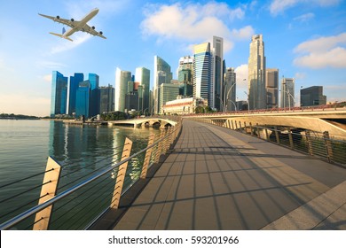 Travel, Transportation concept - Airplane flying over Singapore city in morning time