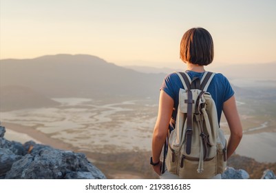 Travel to Turkey, viewpoint over Dalyan Iztuzu Beach. . Smiling woman taking break on hiking trip looking at view at sunset. Explore natural wonders of Turkey - Powered by Shutterstock