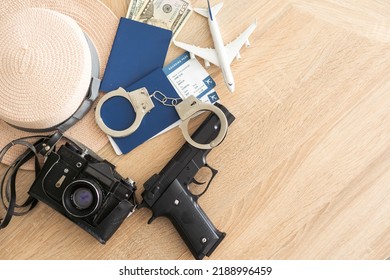 Travel And Vacation Concept, Passport, Money And Gun On Wood Top Table.