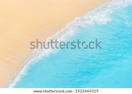 Travel and vacation image. Beach. Seascape. Coast as a background from top view. Blue water background from air. Strong waves.