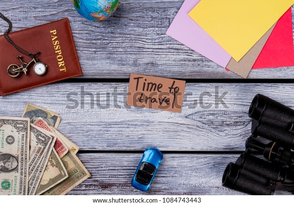 Travel And Vacation Items On Table. Overhead top\
view, flat lay, accessories and essential travel items on grey\
wooden table.