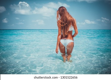 Travel vacation wallpaper - Beautiful young pretty blonde girl in white bikini with white sand on her perfect sport sexy body relax in sea of white sand paradise tropical maldives beach at sunny day 