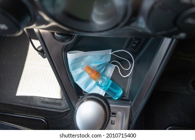 Travel And Vacations Concept, Medical Mask, Top View Of Hand Sanitizer Spray Placed On Console Inside The Car, Preparation Of Portable Disinfecting Alcohol Spray, Prevention Of Covid-19, Health Care.