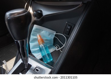 Travel And Vacations Concept, Medical Mask, Hand Sanitizer Spray Placed On Console Inside The Car, Preparation Of Portable Disinfecting Alcohol Spray, Prevention Of Covid-19, Health Care, New Normal.