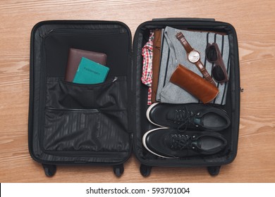 Travel and vacations concept. Open traveler's bag with clothing and accessories.