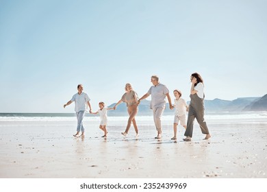 Travel, walking and big family holding hands at the beach on vacation, holiday or adventure together. Bonding, fun and children with parents and grandparents by ocean for fresh air on a weekend trip. - Powered by Shutterstock