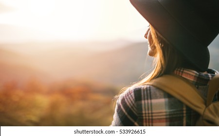 Travel Woman With Backpack And Hat Enjoy Sunset. Close Up Of Travel Girl Outdoors
